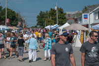 Visitors enjoy midway booths and vendors at Oktoberfest 2016.